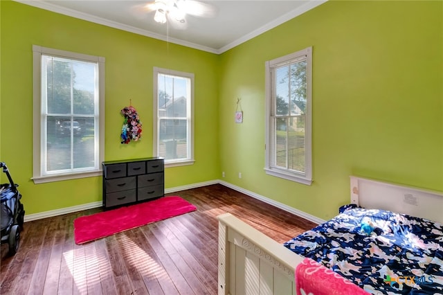 bedroom with ornamental molding, dark hardwood / wood-style flooring, and ceiling fan