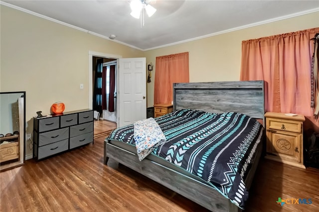 bedroom featuring ornamental molding, dark hardwood / wood-style floors, and ceiling fan