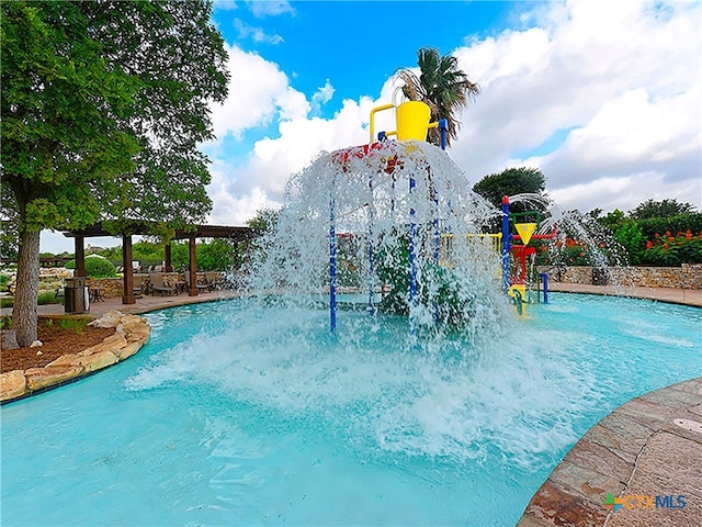 view of swimming pool featuring a pergola