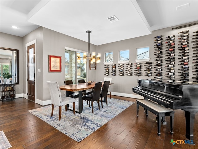 dining space with an inviting chandelier and dark hardwood / wood-style floors