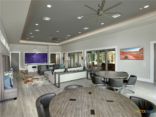 dining area with french doors, plenty of natural light, ceiling fan, and a tray ceiling