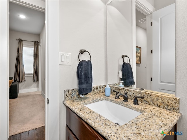 bathroom with vanity and wood-type flooring