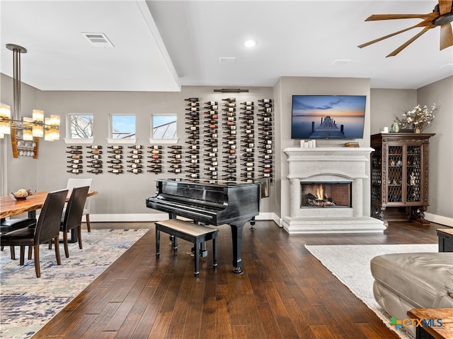 interior space with dark hardwood / wood-style flooring and ceiling fan with notable chandelier