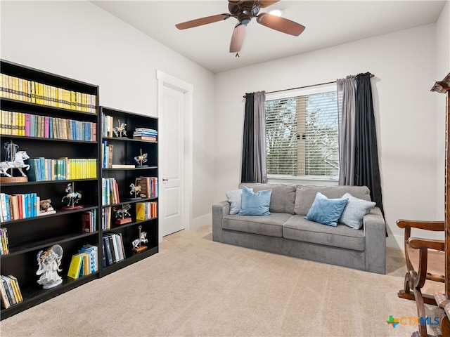 sitting room with light colored carpet and ceiling fan