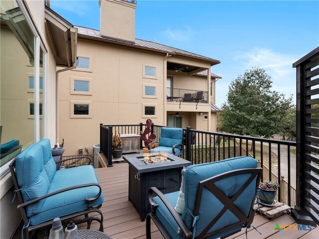 wooden deck with a fire pit