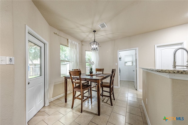 4431 Hogg, San Antonio, TX 78223 - dining area with a chandelier and light tile patterned flooring