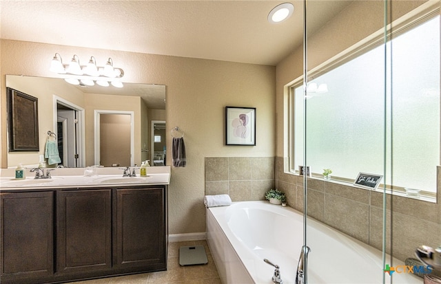 4431 Hogg, San Antonio, TX 78223 - bathroom with double vanity, a bath, and tile patterned flooring