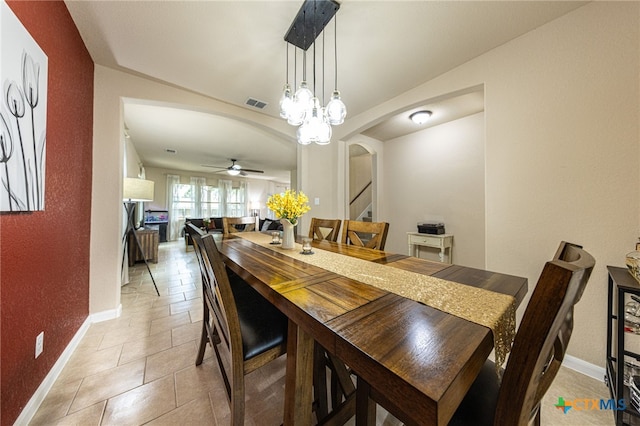 4431 Hogg, San Antonio, TX 78223 - dining room with arched walkways, stairs, a ceiling fan, lofted ceiling, and light tile patterned flooring