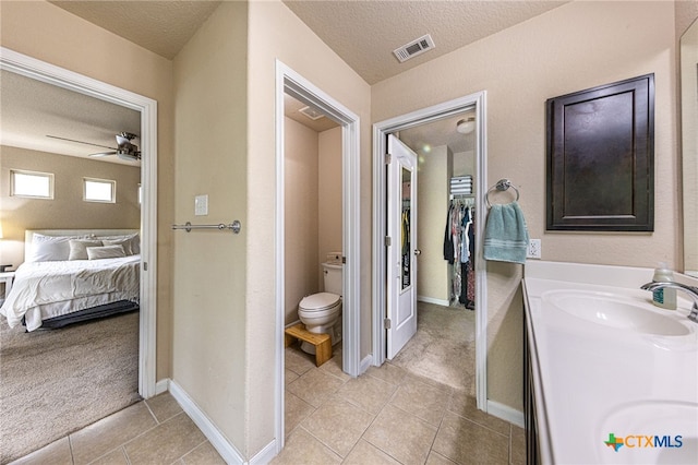4431 Hogg, San Antonio, TX 78223 - full bath featuring a ceiling fan, a textured ceiling, double vanity, tile patterned floors, and connected bathroom
