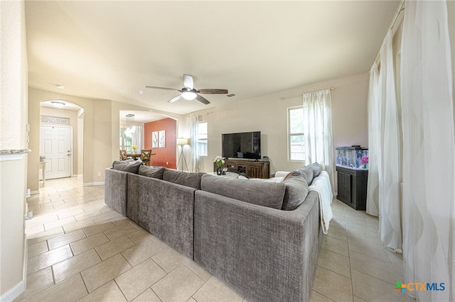 4431 Hogg, San Antonio, TX 78223 - living area featuring arched walkways, ceiling fan, and light tile patterned floors