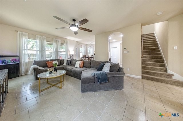 4431 Hogg, San Antonio, TX 78223 - living room featuring a ceiling fan, stairway, arched walkways, light tile patterned flooring, and plenty of natural light