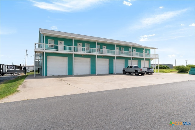 view of front of house with a balcony and a garage