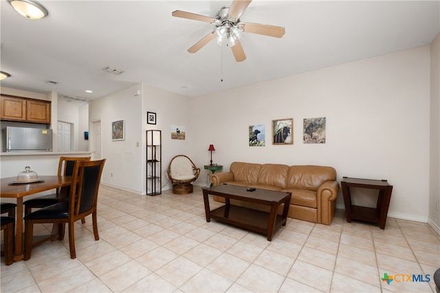 tiled living room with ceiling fan