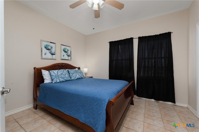 tiled bedroom featuring ceiling fan