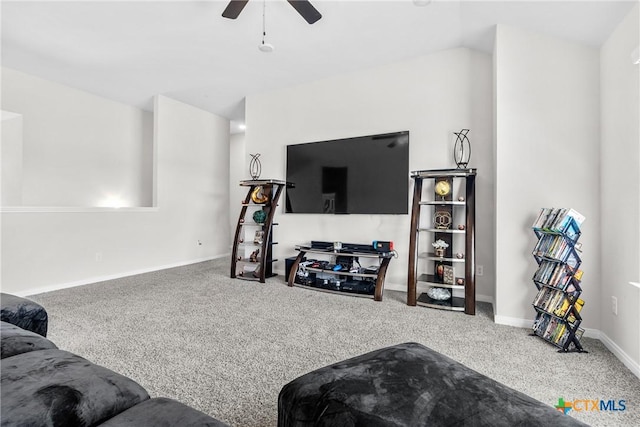 living room with baseboards, lofted ceiling, ceiling fan, and carpet flooring