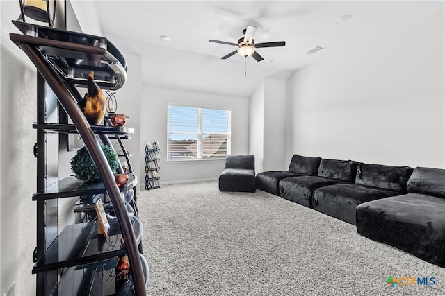 carpeted living room with lofted ceiling, a ceiling fan, and visible vents