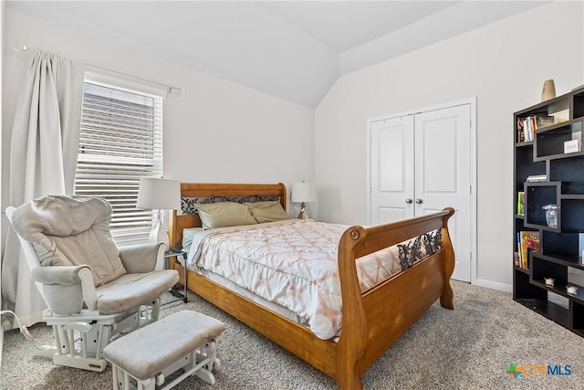 bedroom featuring lofted ceiling, baseboards, a closet, and carpet floors