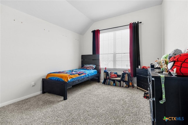 bedroom featuring vaulted ceiling, carpet flooring, and baseboards