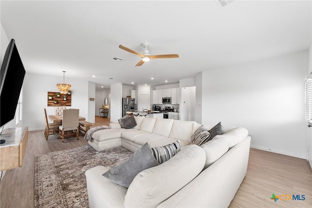 5903 Geronimo Vis, Seguin, TX 78155 - living area with a ceiling fan, baseboards, light wood finished floors, and recessed lighting