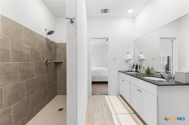 5903 Geronimo Vis, Seguin, TX 78155 - bathroom with ensuite bathroom, double vanity, walk in shower, and wood finished floors