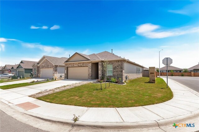 5903 Geronimo Vis, Seguin, TX 78155 - view of front facade featuring driveway, brick siding, an attached garage, and a residential view