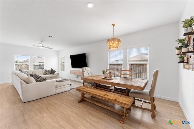 5903 Geronimo Vis, Seguin, TX 78155 - living room with light wood-style flooring, baseboards, and a chandelier