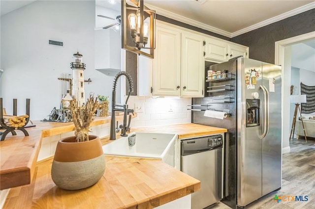 1811 Rally Ln, Harker Heights, TX 76548 - kitchen with stainless steel appliances, a sink, wood counters, crown molding, and backsplash