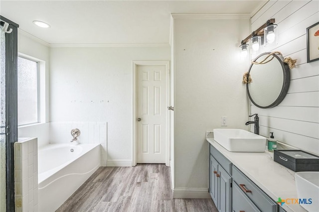 1811 Rally Ln, Harker Heights, TX 76548 - full bath featuring crown molding, wood finished floors, a garden tub, double vanity, and baseboards