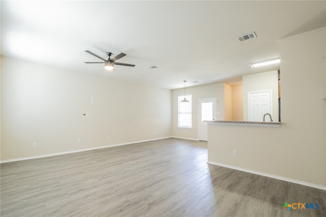 empty room with wood-type flooring and ceiling fan