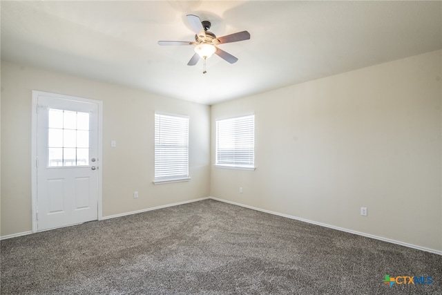 spare room featuring carpet floors, ceiling fan, and a healthy amount of sunlight