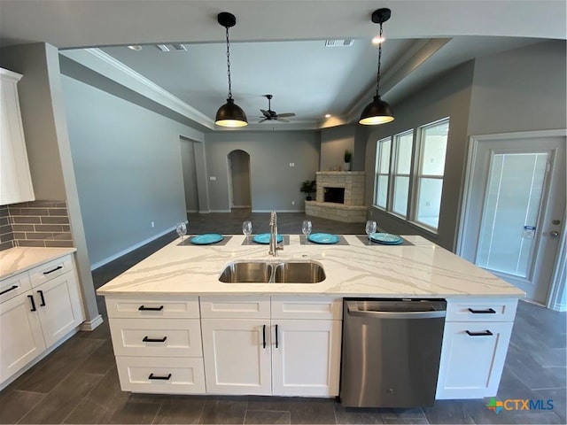 120 S Calvin Barrett, Blanco, TX 78606 - kitchen with stainless steel dishwasher, a ceiling fan, backsplash, arched walkways, and pendant lighting