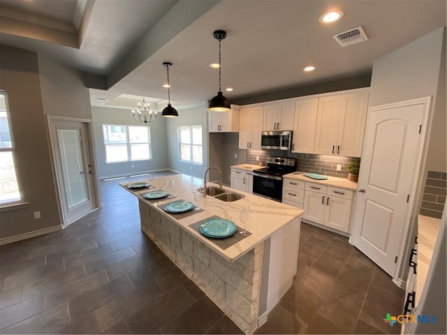 120 S Calvin Barrett, Blanco, TX 78606 - kitchen featuring stainless steel appliances, white cabinets, a chandelier, decorative backsplash, and recessed lighting