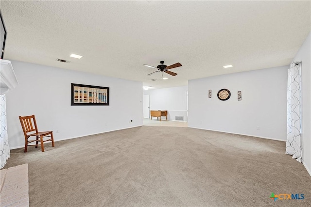 296 Valiant Wills Rd, Bruceville-Eddy, TX 76630 - unfurnished living room featuring a ceiling fan, carpet, and a textured ceiling