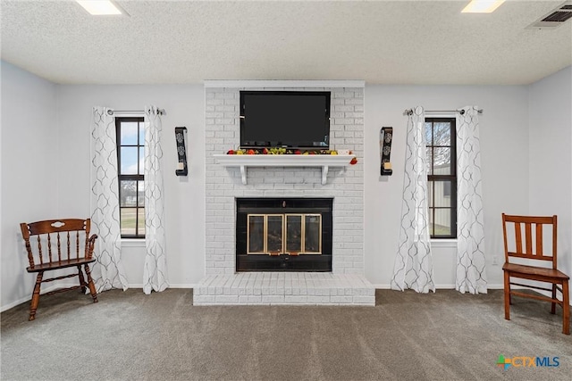 296 Valiant Wills Rd, Bruceville-Eddy, TX 76630 - carpeted living area featuring a textured ceiling, a brick fireplace, and baseboards