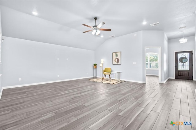 unfurnished living room with ceiling fan, light wood-type flooring, and vaulted ceiling