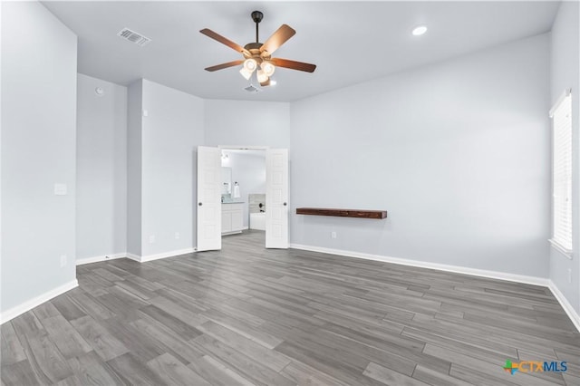 unfurnished living room featuring dark hardwood / wood-style floors and ceiling fan