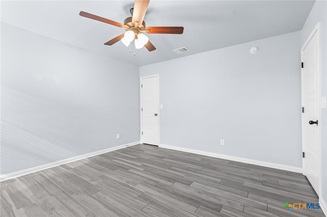 unfurnished room featuring ceiling fan and dark wood-type flooring