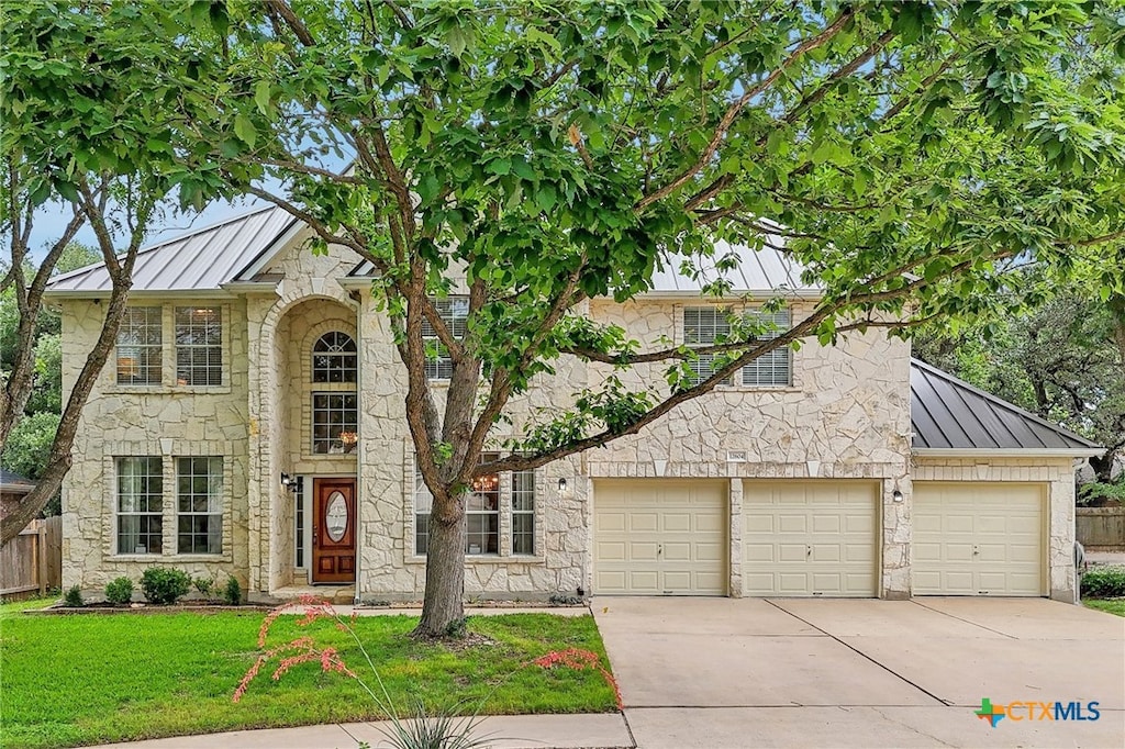 12604 Duckcreek Ct, Austin, TX 78729 - view of front of house featuring a standing seam roof, metal roof, and stone siding