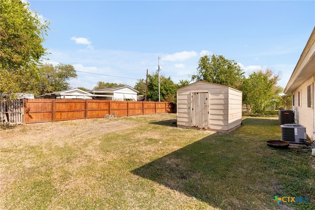 view of yard with cooling unit and a storage shed