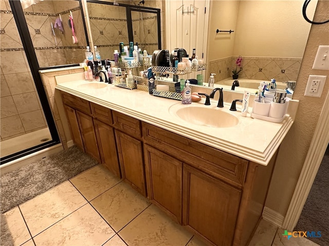 bathroom with tile patterned floors, vanity, and separate shower and tub