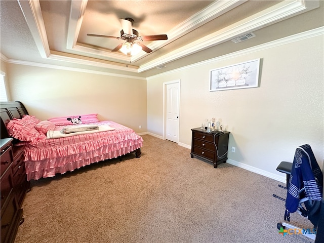 bedroom with ceiling fan, crown molding, light carpet, and a tray ceiling