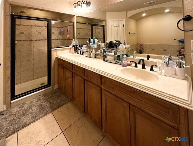 bathroom featuring tile patterned flooring, vanity, and plus walk in shower