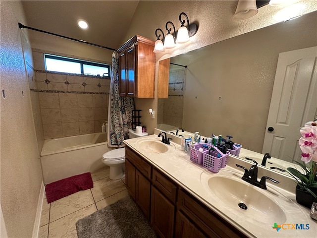 full bathroom featuring toilet, tile patterned flooring, vanity, and tiled shower / bath