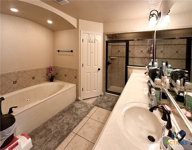 bathroom featuring tile patterned flooring, vanity, a textured ceiling, and shower with separate bathtub