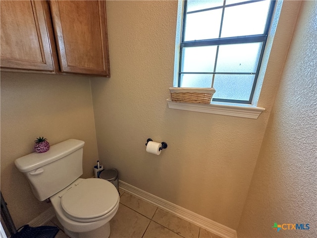 bathroom featuring tile patterned flooring and toilet