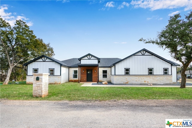 modern farmhouse style home with a front lawn