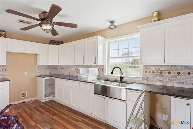 kitchen featuring dark wood-type flooring, decorative backsplash, and white cabinets