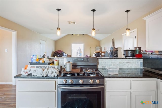 kitchen with gas stove, tasteful backsplash, white cabinetry, dark hardwood / wood-style flooring, and lofted ceiling