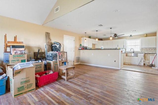 interior space featuring light wood-type flooring, ceiling fan, and sink