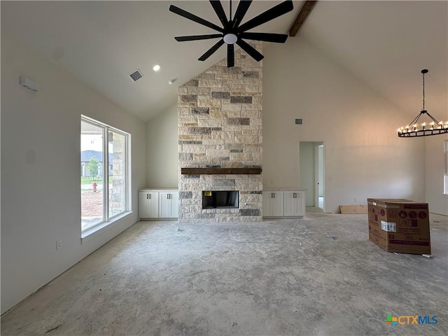 unfurnished living room featuring visible vents, a fireplace, beam ceiling, high vaulted ceiling, and ceiling fan with notable chandelier